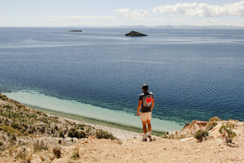 Alex travel influencer from mountain top watching the beach