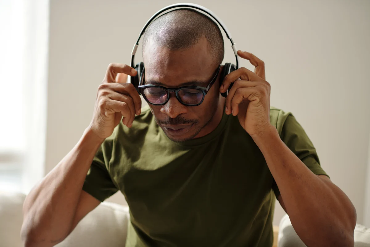 man putting on headphones