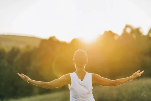 acceptance mature woman with open arms in nature