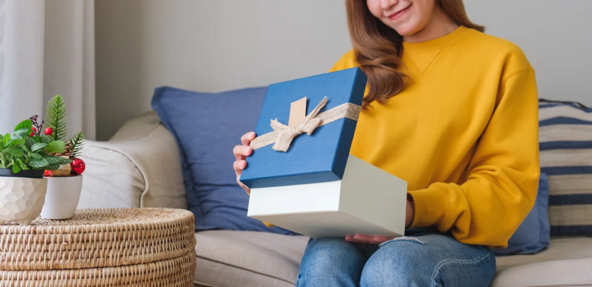 young woman receiving and opening a gift box