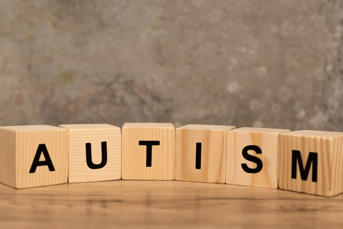 cubes with autism lettering on wooden table